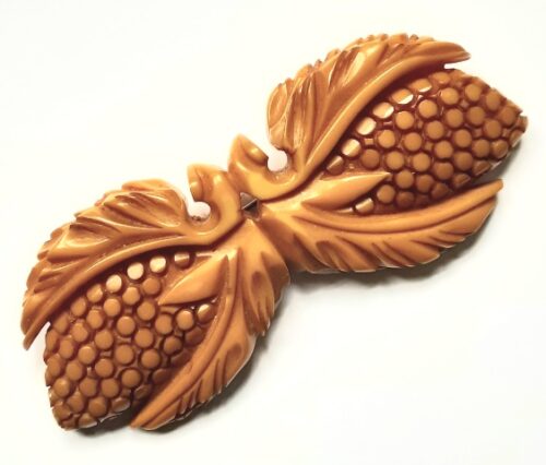 carved yellow bakelite brooch