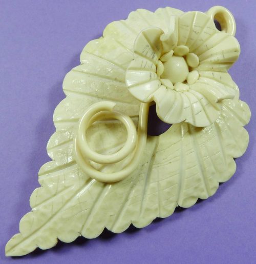 Cream celluloid flower brooch