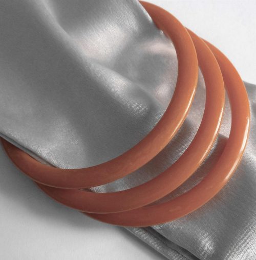 3 orange bakelite spacer bangles