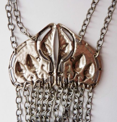 white metal necklace on chains back