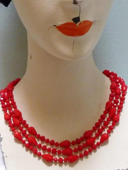 long red glass bead necklace on dummy