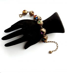 gilt ball and stones bracelet on hand